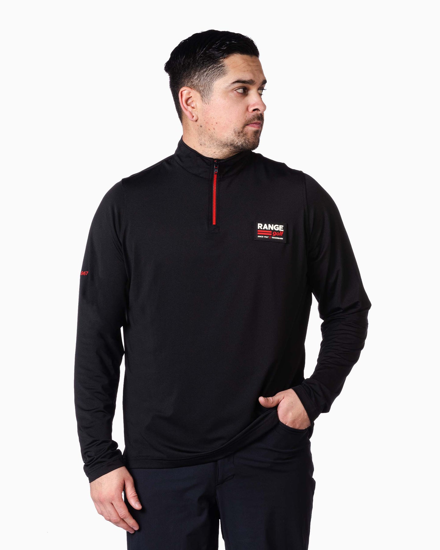 man wearing black quarter zip with range label on pocket