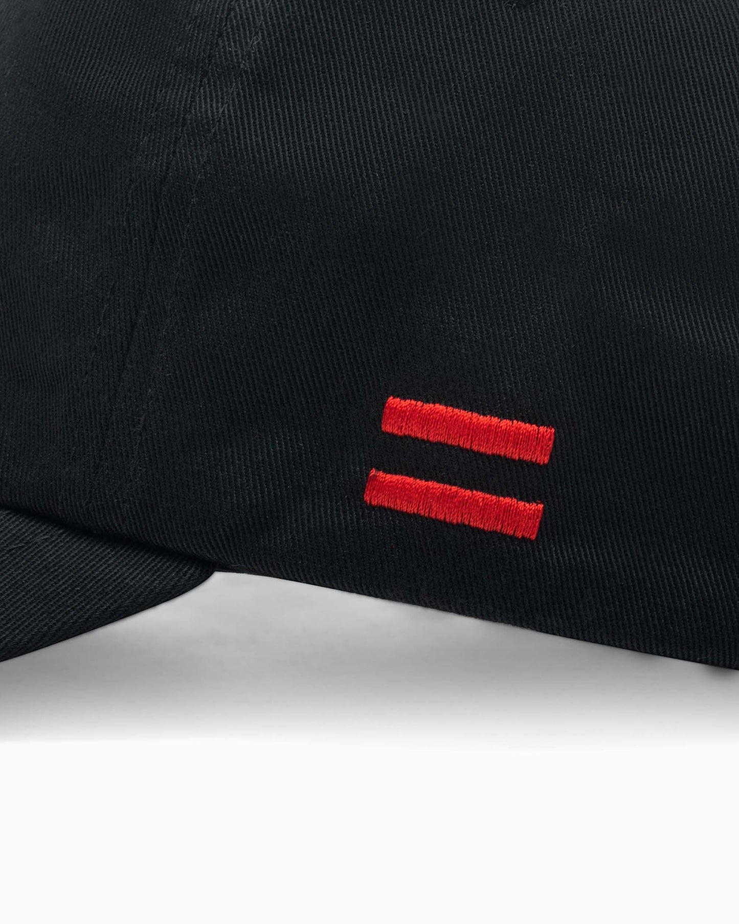 close up of side of hat with two red woven stripes