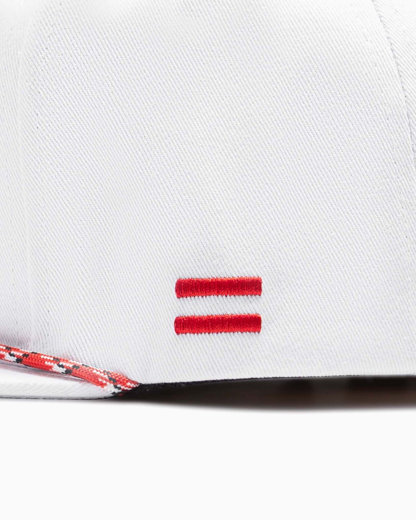 close up of side of hat with two red woven stripes 